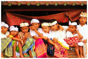 Balinese children watching religious ceremony